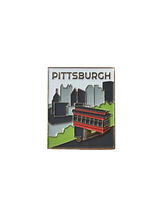 Pittsburgh-themed enamel pin with skyline green trees and the Duquesne Incline in the foreground with "PITTSBURGH" at the top.