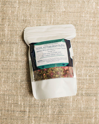 Tea package with a label on a textured beige surface