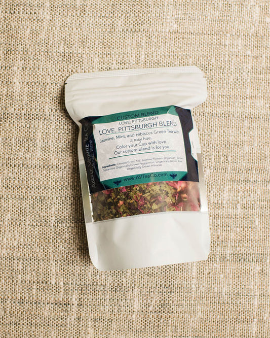 Tea package with a label on a textured beige surface