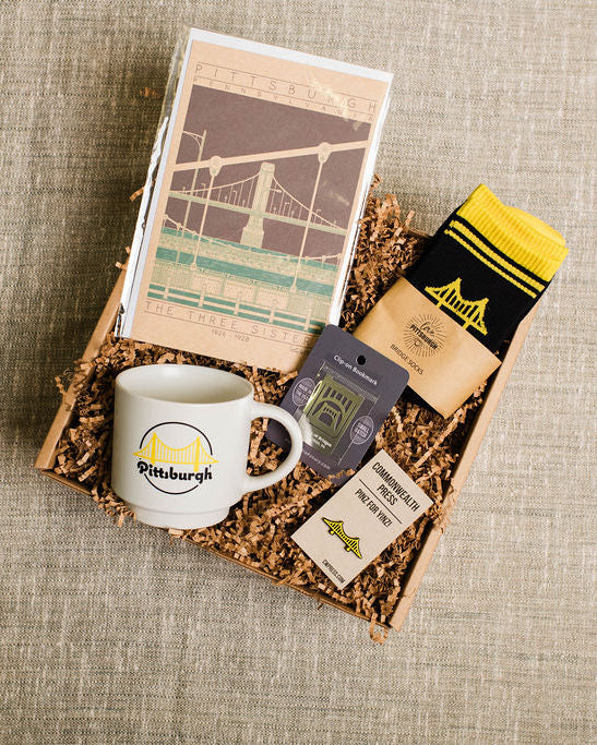 Gift set with bridge themed mug, cards, and socks on a textured surface