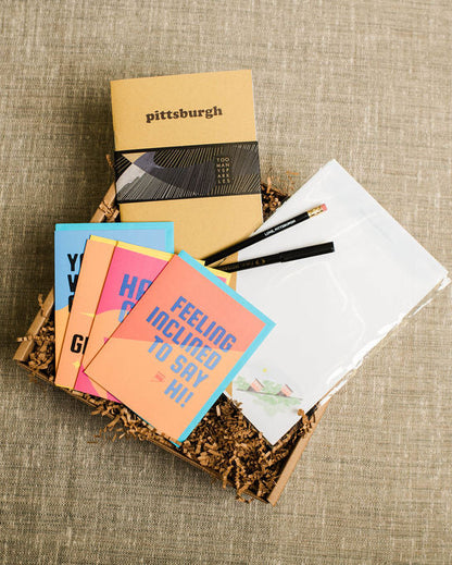Collection of pittsburgh greeting cards and stationery items on a textured surface