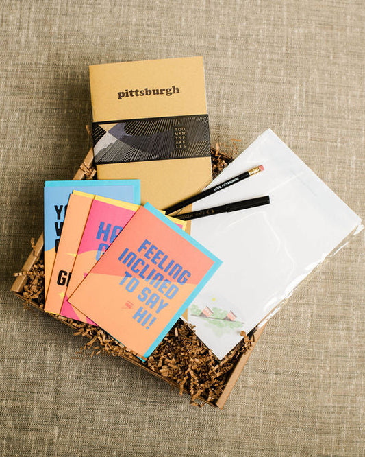 Collection of pittsburgh greeting cards and stationery items on a textured surface