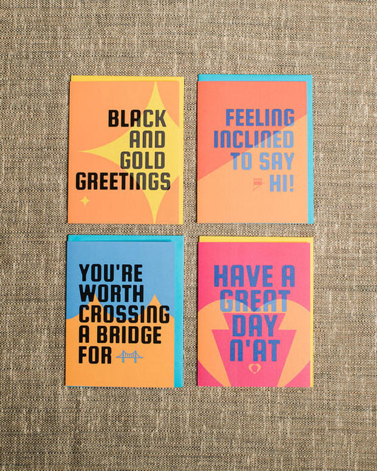 Four colorful pittsburgh greeting cards with text on a textured fabric background