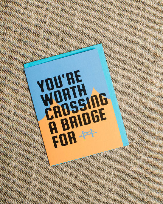 pittsburgh card with text 'You're worth crossing a bridge for' on a textured fabric background