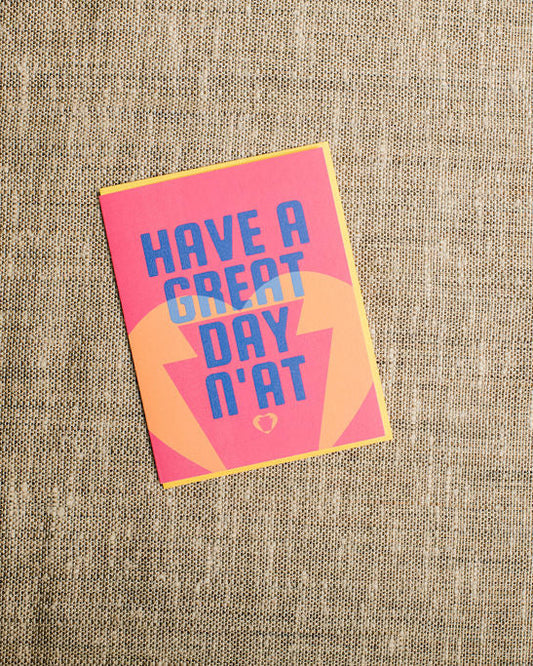 Card with 'Have a great day n'at' text on a textured fabric background