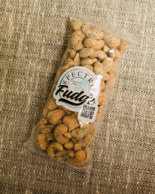 Bag of dill pickle cashews on a textured beige background