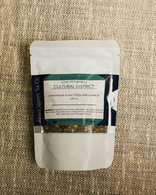 cultural district tea blend  with a label on a textured beige surface