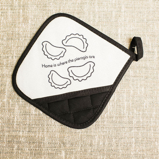 Potholder with pierogi design and text on a beige fabric background