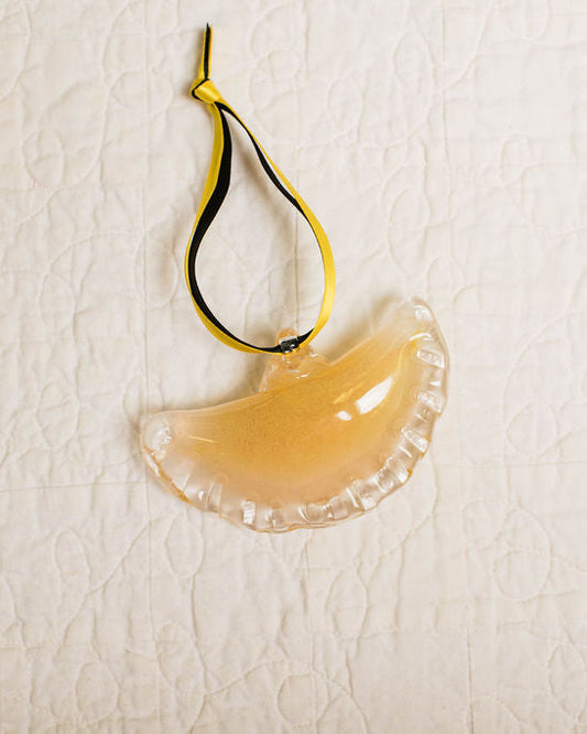 glass pierogi ornament with black and gold ribbon