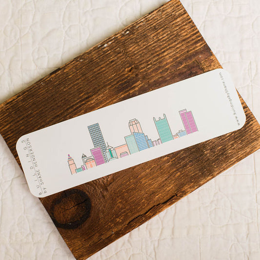 Bookmark with colorful pittsburgh cityscape design on a wooden surface