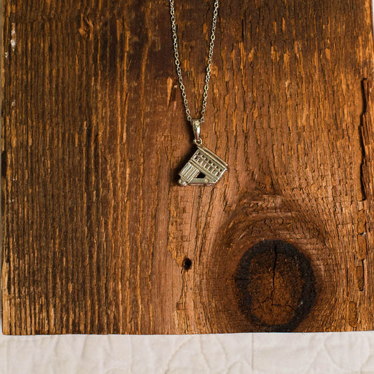 Necklace with a incline pendant on a wooden surface