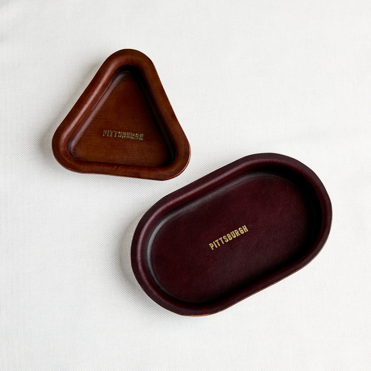 brown leather oval and triangle trays with gold embossed "pittsburgh"