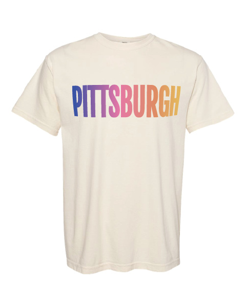 Beige t-shirt with 'Pittsburgh' in colorful letters on a white background