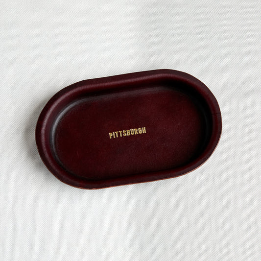 brown leather oval shape tray with embossed gold "pittsburgh"