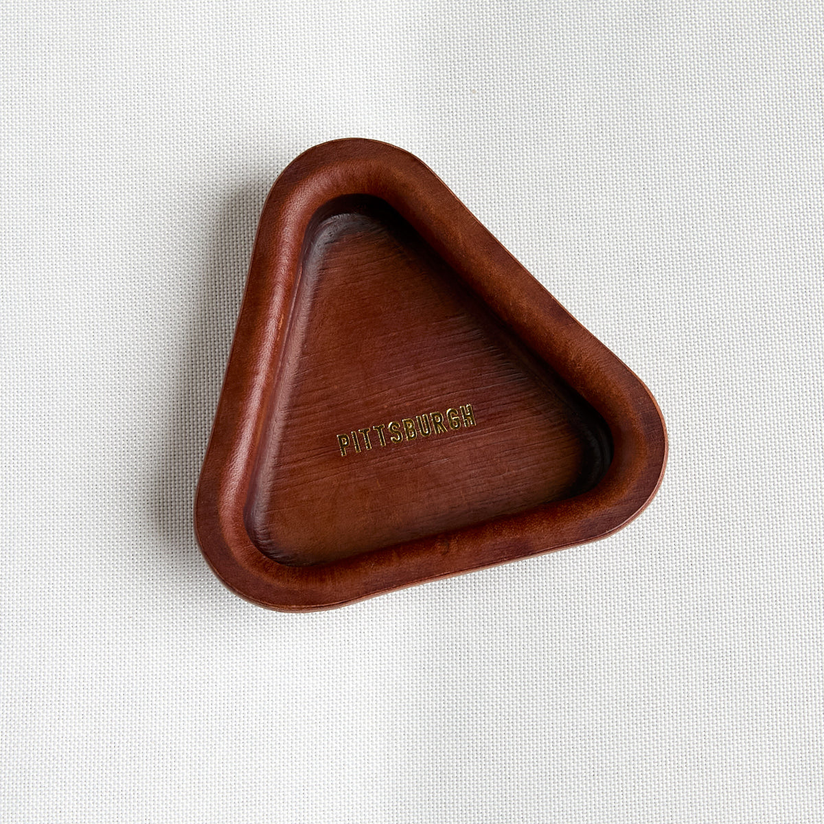 brown leather triangle tray with embossed gold "pittsburgh"